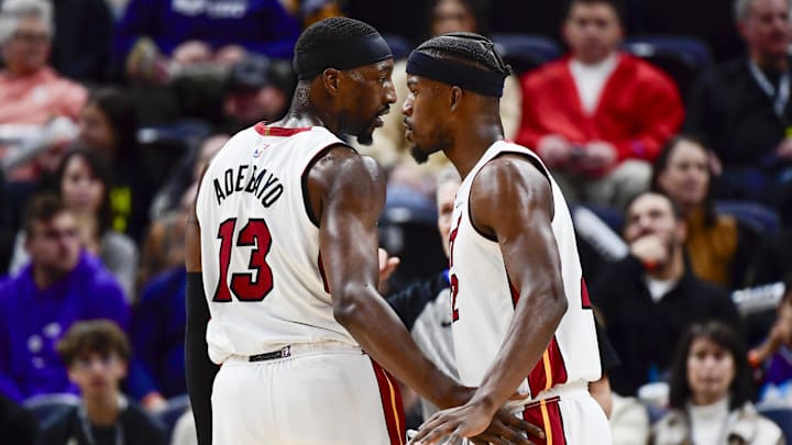 Dec 31, 2022; Salt Lake City, Utah, USA; Miami Heat forward Jimmy Butler (22) and center/forward Bam Adebayo (13) talk before a free-throw shot against the Utah Jazz during the second half at Vivint Arena. Mandatory Credit: Christopher Creveling-Imagn Images