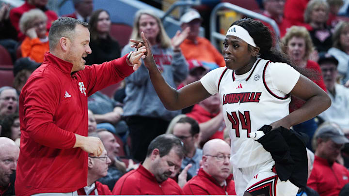 Louisville head coach Jeff Walz greeted Olivia Cochran (44) after subbing her out of the game on senior night against Clemson at the KFC Yum! Center in Louisville, Ky. on Feb. 27, 2025. Louisville won 78-52.