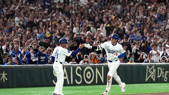 Mar 15, 2025; Bunkyo, Tokyo, Japan; Los Angeles Dodgers designated hitter Shohei Ohtani (right) celebrates with third base coach/outfield coach Dino Ebel (91) after hitting a home run against the Yomiuri Giants during the third inning at Tokyo Dome. Mandatory Credit: Darren Yamashita-Imagn Images