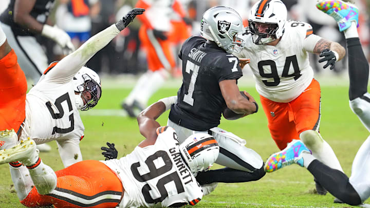 Nov 23, 2025; Paradise, Nevada, USA; Las Vegas Raiders quarterback Geno Smith (7) is sacked by Cleveland Browns defensive end Myles Garrett (95) as defensive tackle Mason Graham (94) looks make a tackle on the play during the fourth quarter at Allegiant Stadium. Mandatory Credit: Stephen R. Sylvanie-Imagn Images