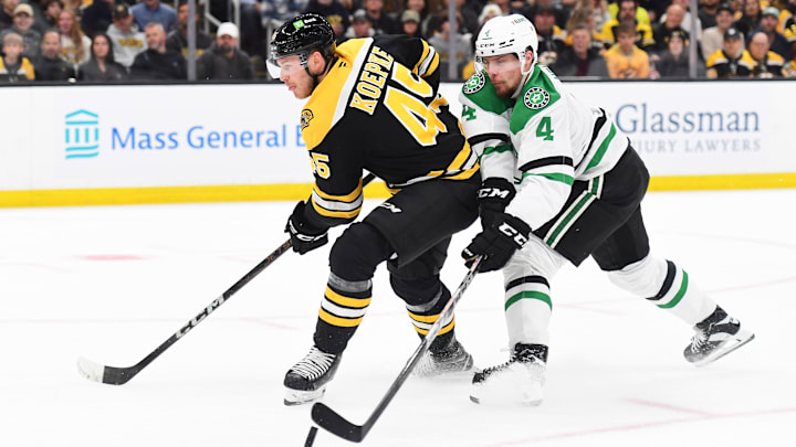 Oct 24, 2024; Boston, Massachusetts, USA;  Dallas Stars defenseman Miro Heiskanen (4) deflects the puck away from Boston Bruins left wing Cole Koepke (45) during the first period at TD Garden. Mandatory Credit: Bob DeChiara-Imagn Images