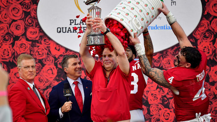 Indiana coach Curt Cignetti lifts the trophy as players celebrate with a rose petal dunk after defeating the Alabama Crimson Tide in the 2026 Rose Bowl and quarterfinal game of the College Football Playoff at Rose Bowl Stadium.