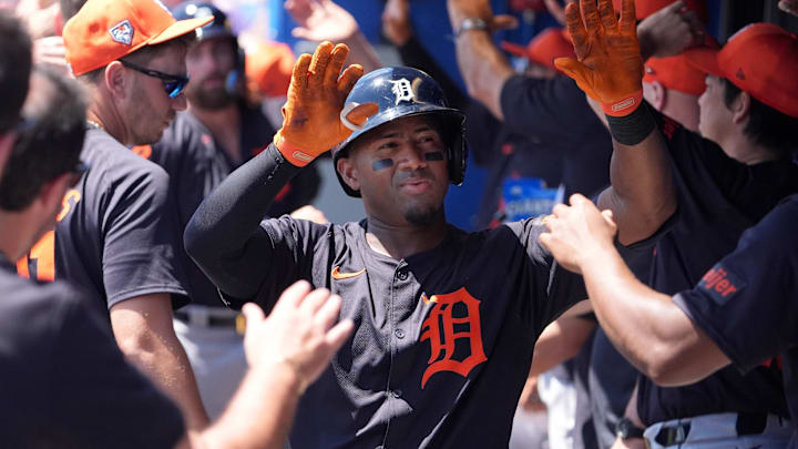 Detroit Tigers second baseman Andy Ibanez (77) is congratulated while walking through the dugout.