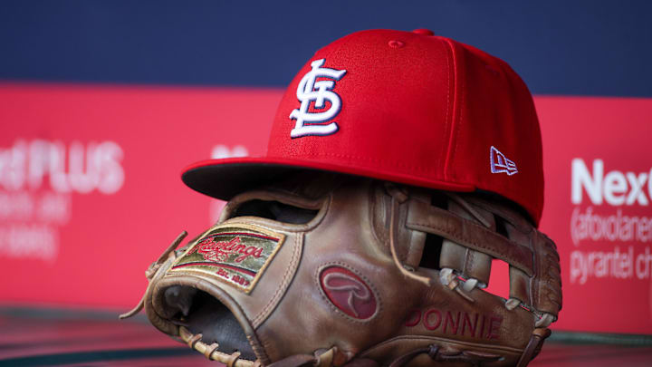 Apr 21, 2025; Atlanta, Georgia, USA; A St. Louis Cardinals hat and glove in the dugout against the Atlanta Braves in the first inning at Truist Park. Mandatory Credit: Brett Davis-Imagn Images
