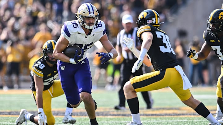 Huskies tight end Keleki Latu (85) runs through the Iowa secondary after catching a Will Rogers pass. 