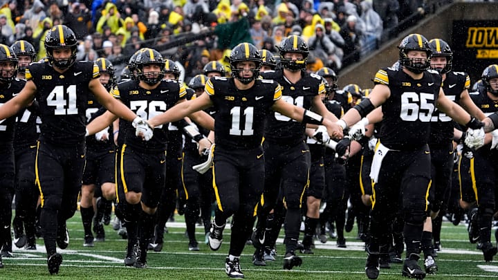 The Iowa Hawkeyes swarm onto the field Nov. 8, 2025, ahead of a Big Ten Football game against the Oregon Ducks at Kinnick Stadium in Iowa City, Iowa.