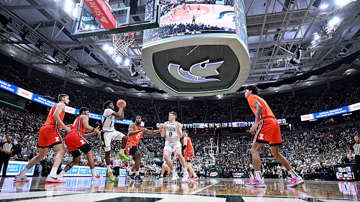 Jan 19, 2025; East Lansing, Michigan, USA;  Michigan State Spartans guard Jase Richardson (11) drives into the paint against the Illinois Fighting Illini defense during the second half at Jack Breslin Student Events Center. Mandatory Credit: Dale Young-Imagn Images