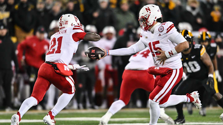 Nov 29, 2024; Iowa City, Iowa, USA; Nebraska Cornhuskers quarterback Dylan Raiola (15) hands the ball off to running back Emmett Johnson (21) against the Iowa Hawkeyes during the first quarter at Kinnick Stadium. Nov 29, 2024; Iowa City, Iowa, USA; Nebraska Cornhuskers quarterback Dylan Raiola (15) hands the ball off to running back Emmett Johnson (21) against the Iowa Hawkeyes during the first quarter at Kinnick Stadium.
