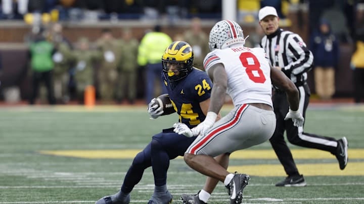 Nov 29, 2025; Ann Arbor, Michigan, USA; Michigan Wolverines running back Bryson Kuzdzal (24) runs the ball defended by Ohio State Buckeyes linebacker Arvell Reese (8) in the first half at Michigan Stadium. Mandatory Credit: Rick Osentoski-Imagn Images Nov 29, 2025; Ann Arbor, Michigan, USA; Michigan Wolverines running back Bryson Kuzdzal (24) runs the ball defended by Ohio State Buckeyes linebacker Arvell Reese (8) in the first half at Michigan Stadium. Mandatory Credit: Rick Osentoski-Imagn Images