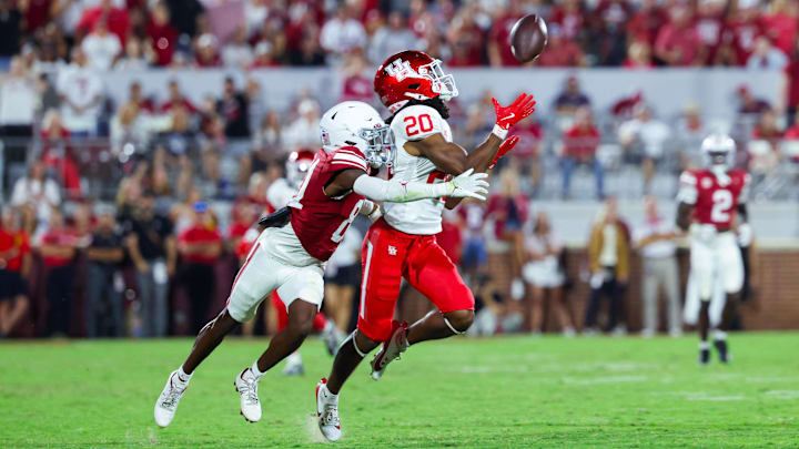 Sep 7, 2024; Norman, Oklahoma, USA;  Houston Cougars defensive back Jeremiah Wilson (20) makes an interception in front of Oklahoma Sooners wide receiver Zion Ragins (81) but it is called back for a penalty during the second half at Gaylord Family-Oklahoma Memorial Stadium. Mandatory Credit: Kevin Jairaj-Imagn Images