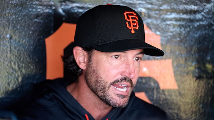 Apr 2, 2026; San Francisco, California, USA; San Francisco Giants manager Tony Vitello (23) speaks to the media in the dugout before the game against the New York Mets at Oracle Park. Mandatory Credit: Robert Edwards-Imagn Images