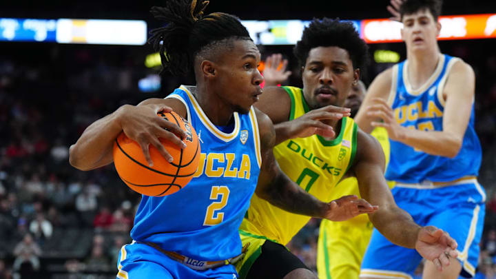 UCLA Bruins guard Dylan Andrews (2) dribbles the ball against Oregon Ducks guard Kario Oquendo (0) in the first half at T-Mobile Arena.