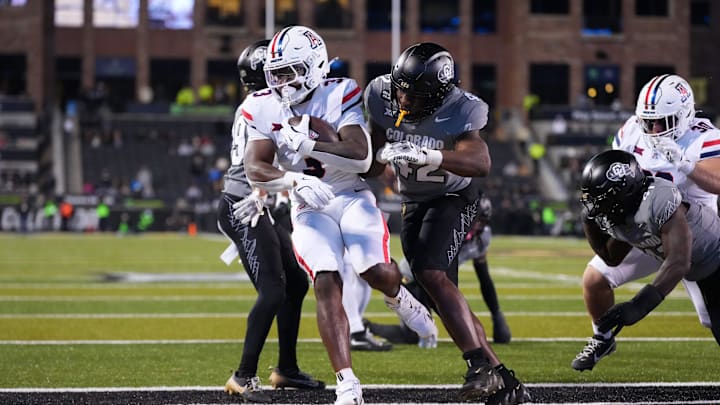 Nov 1, 2025; Boulder, Colorado, USA; Arizona Wildcats running back Kedrick Reescano (3) scores a touchdown past Colorado Buffaloes linebacker Jeremiah Brown (42) in the second half at Folsom Field. Mandatory Credit: Ron Chenoy-Imagn Images