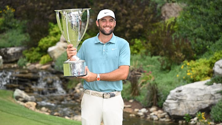 Aug 17, 2025; Owings Mills, Maryland, USA; Scottie Scheffler poses with the J. K. Wadley Trophy after winning the BMW Championship golf tournament. Mandatory Credit: Rafael Suanes-Imagn Images