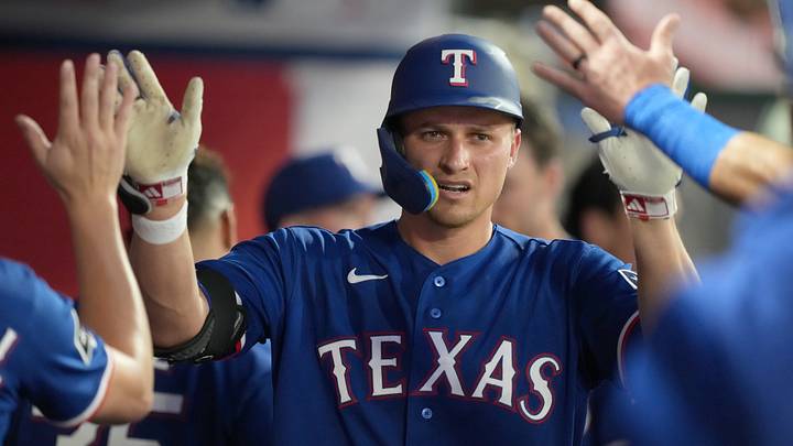 Texas Rangers shortstop Corey Seager (5) is congratulated by teammates after hitting a home run. 