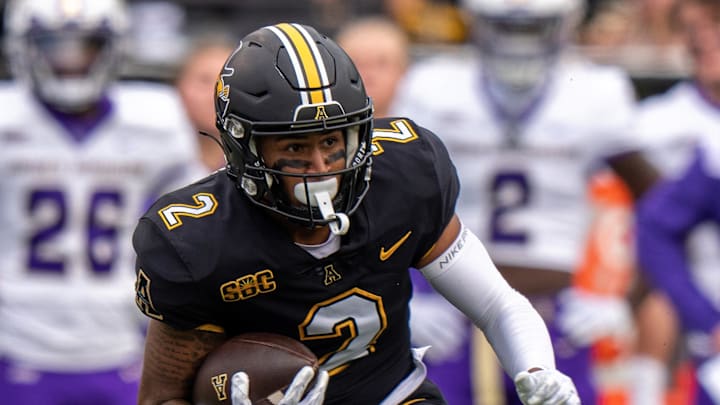 Sep 24, 2022; Boone, North Carolina, USA; Appalachian State Mountaineers wide receiver Kaedin Robinson (2) runs the ball in the first quarter against the James Madison Dukes at Kidd Brewer Stadium. Mandatory Credit: David Yeazell-Imagn Images