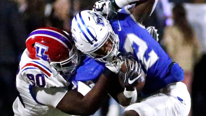 Middle Tennessee running back Jaiden Credle (22) runs the ball as he tries to shake off Louisiana Tech defensive lineman David Blay (90) during the football game in Floyd Stadium at Middle Tennessee, in Murfreesboro, Tenn. on Tuesday, Oct. 10, 2023.