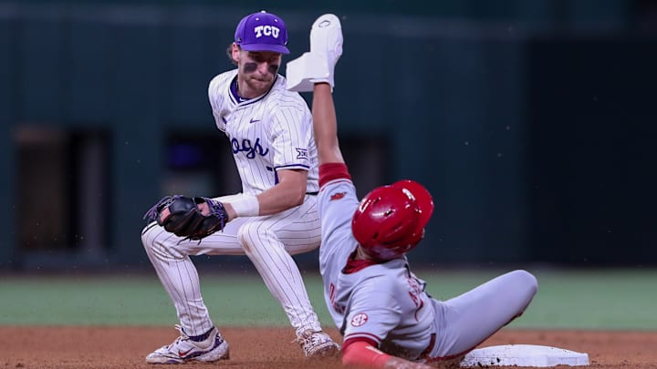 Cole Cramer attempts to apply a tag on an Arkansas hitter at Globe Life Field. 