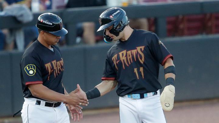 Wisconsin Timber Rattlers' manager Victor Estevez (7) congratulates Andrew Fischer (11) getting to third base during their baseball game against the Quad Cities River Bandits Wednesday, August 27, 2025, at Neuroscience Group Field at Fox Cities Stadium in Grand Chute, Wisconsin. Quad City won 9-5.