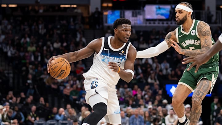 Feb 12, 2025; Minneapolis, Minnesota, USA; Minnesota Timberwolves guard Anthony Edwards (5) dribbles against Milwaukee Bucks guard Gary Trent Jr. (5) in the first quarter at Target Center.