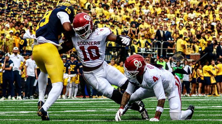 Oklahoma linebacker Kip Lewis tries to tackle Michigan quarterback Bryce Underwood. Oklahoma linebacker Kip Lewis tries to tackle Michigan quarterback Bryce Underwood.