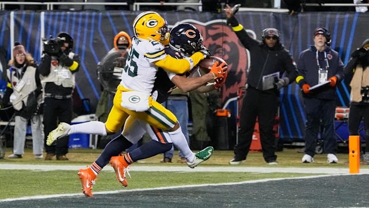 Dec 20, 2025; Chicago, Illinois, USA; Chicago Bears wide receiver DJ Moore (2) catches the game-winning forty-six yard touchdown pass thrown by quarterback Caleb Williams (not pictured) against Green Bay Packers cornerback Keisean Nixon (25) in overtime at Soldier Field. Mandatory Credit: David Banks-Imagn Images