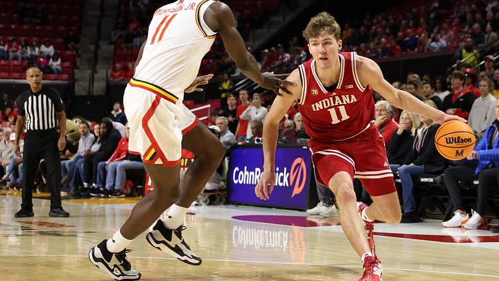 Jan 7, 2026; College Park, Maryland, USA; Indiana Hoosiers forward Trent Sisley (11) drives past Maryland Terrapins guard George Turkson Jr. (11) during the first half at Xfinity Center. Mandatory Credit: Daniel Kucin Jr.-Imagn Images