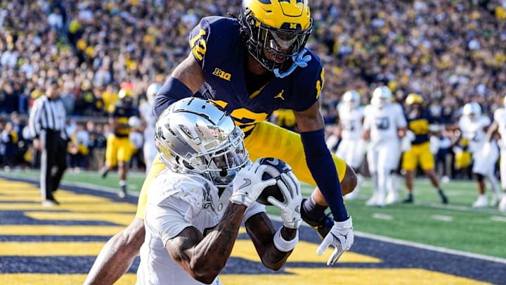 Oregon wide receiver Evan Stewart (7) makes a catch for a touchdown against Michigan defensive back Aamir Hall (12) during the first half at Michigan Stadium in Ann Arbor on Saturday, Nov. 2, 2024. Oregon wide receiver Evan Stewart (7) makes a catch for a touchdown against Michigan defensive back Aamir Hall (12) during the first half at Michigan Stadium in Ann Arbor on Saturday, Nov. 2, 2024.