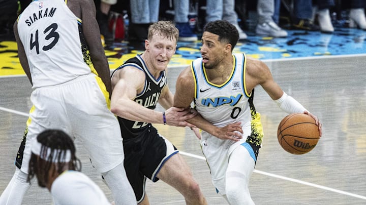 Apr 19, 2025; Indianapolis, Indiana, USA; Indiana Pacers guard Tyrese Haliburton (0) dribbles the ball while Milwaukee Bucks guard AJ Green (20) defends in the second half at Gainbridge Fieldhouse. Mandatory Credit: Trevor Ruszkowski-Imagn Images