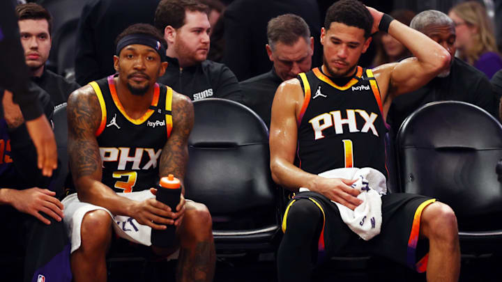 Apr 9, 2025; Phoenix, Arizona, USA; Phoenix Suns guard Bradley Beal (3) and guard Devin Booker (1) react on the bench against the Oklahoma City Thunder during the fourth quarter at Footprint Center. Mandatory Credit: Mark J. Rebilas-Imagn Images