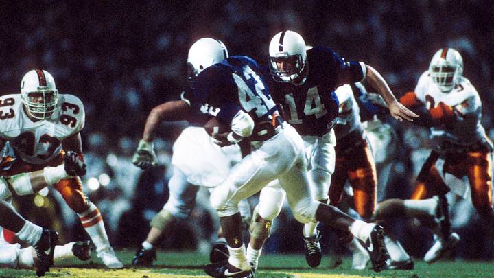 Penn State Nittany Lions quarterback John Shaffer (14) hands the ball off to running back D.J. Dozier (42) during the 1987 Fiesta Bowl against the Miami Hurricanes. Penn State Nittany Lions quarterback John Shaffer (14) hands the ball off to running back D.J. Dozier (42) during the 1987 Fiesta Bowl against the Miami Hurricanes.