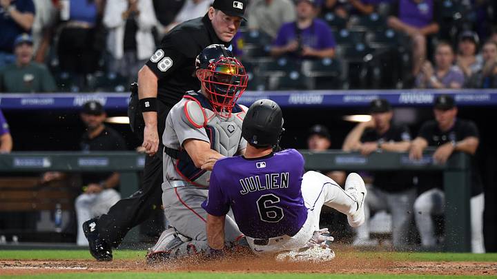 Colorado Rockies infielder Edouard Julien slides home