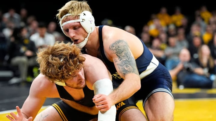 Penn State Nittany Lions wrestler Josh Barr scores a takedown against Iowa’s Brody Sampson in a 197-pound match.