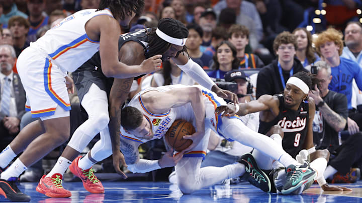 Nov 20, 2024; Oklahoma City, Oklahoma, USA; Oklahoma City Thunder center Isaiah Hartenstein (55) fights for a loose ball with Portland Trail Blazers center Robert Williams III (35) and forward Jerami Grant (9) during the second half at Paycom Center. Mandatory Credit: Alonzo Adams-Imagn Images