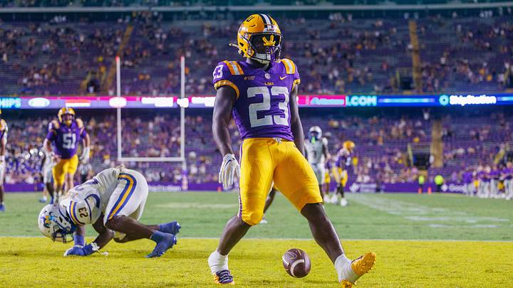 Oct 3, 2026; Baton Rouge, Louisiana, USA; LSU Tigers running back Stacy Gage (23) rushes for a touchdown against McNeese Cowboys defensive end RJ Staten (23) during the second half at Tiger Stadium. Mandatory Credit: Stephen Lew-Imagn Images Oct 3, 2026; Baton Rouge, Louisiana, USA; LSU Tigers running back Stacy Gage (23) rushes for a touchdown against McNeese Cowboys defensive end RJ Staten (23) during the second half at Tiger Stadium. Mandatory Credit: Stephen Lew-Imagn Images