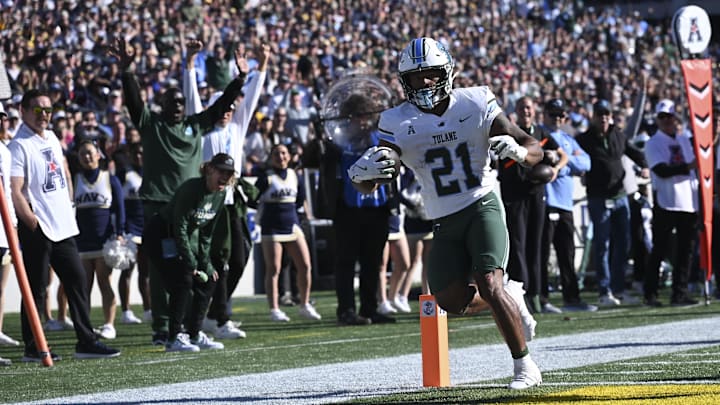 Nov 16, 2024; Annapolis, Maryland, USA;  Tulane Green Wave running back Makhi Hughes (21) scores a touchdown during the first half against the Navy Midshipmen at Navy-Marine Corps Memorial Stadium. Mandatory Credit: Tommy Gilligan-Imagn Images