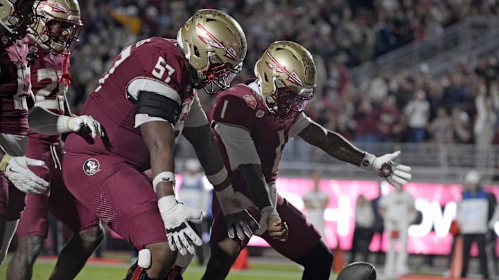 Nov 15, 2025; Tallahassee, Florida, USA; Florida State Seminoles quarterback Tommy Castellanos (1) celebrates a touchdown with offensive lineman Micah Pettus (57) during the second half against the Virginia Tech Hokies at Doak S. Campbell Stadium. Mandatory Credit: Melina Myers-Imagn Images