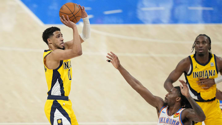 Jun 5, 2025; Oklahoma City, Oklahoma, USA; Indiana Pacers guard Tyrese Haliburton (0) shoots the ball against Oklahoma City Thunder guard Cason Wallace (22) during the fourth quarter in game one of the 2025 NBA Finals at Paycom Center. Mandatory Credit: Kyle Terada-Imagn Images