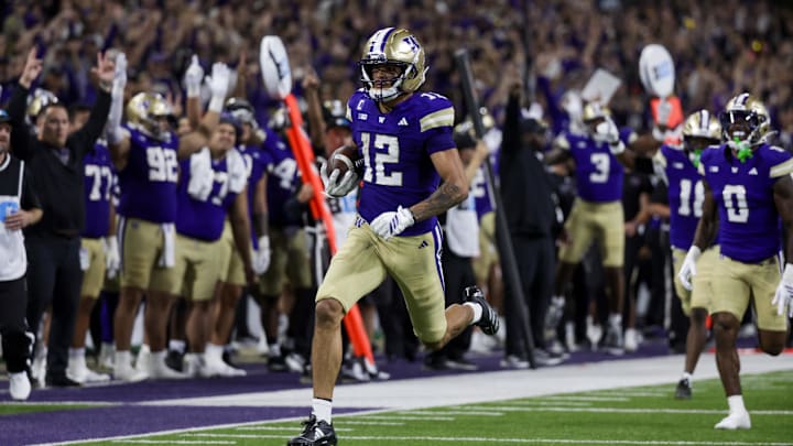 Sep 6, 2025; Seattle, Washington, USA; Washington Huskies wide receiver Denzel Boston (12) returns a punt for a touchdown against the UC Davis Aggies during the second quarter at Husky Stadium. Mandatory Credit: Joe Nicholson-Imagn Images