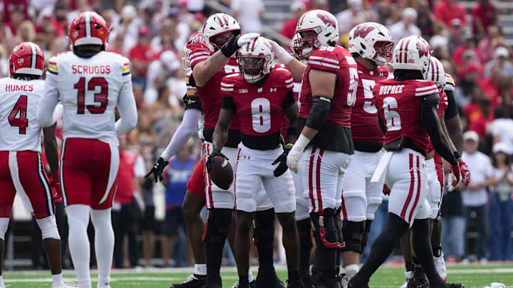 Sep 20, 2025; Madison, Wisconsin, USA;  Wisconsin Badgers wide receiver Vinny Anthony II (8) is congratulated after earning a first down during the second quarter against the Maryland Terrapins at Camp Randall Stadium.