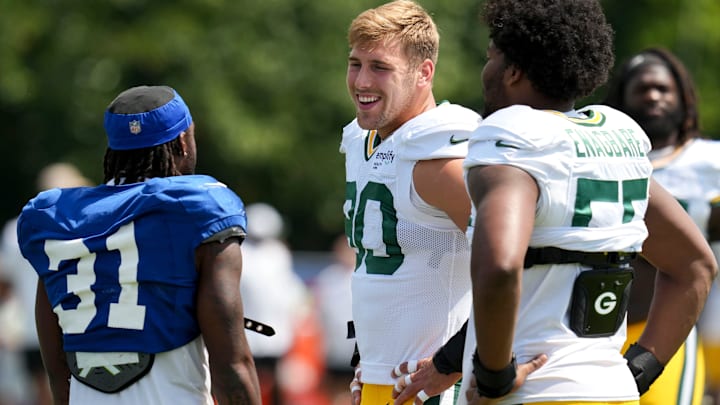 Indianapolis Colts running back Tyler Goodson (31) greets Green Bay Packers defensive linemen Lukas Van Ness (90) and Kingsley Enagbare (55) on Thursday, Aug. 14, 2025, ahead of a joint practice during Indianapolis Colts’ training camp at Grand Park in Westfield.