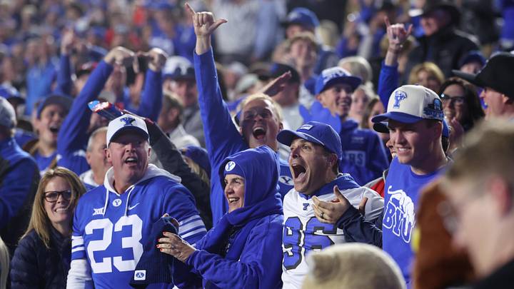 Oct 18, 2025; Provo, Utah, USA; BYU Cougars fans celebrate a touchdown against the Utah Utes during the second half at LaVell Edwards Stadium. Mandatory Credit: Rob Gray-Imagn Images Oct 18, 2025; Provo, Utah, USA; BYU Cougars fans celebrate a touchdown against the Utah Utes during the second half at LaVell Edwards Stadium. Mandatory Credit: Rob Gray-Imagn Images