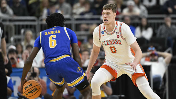 Mar 20, 2025; Providence, RI, USA; McNeese State Cowboys guard Javohn Garcia (6) brings the ball downcourt against Clemson Tigers center Viktor Lakhin (0) during the first half at Amica Mutual Pavilion. Mandatory Credit: Eric Canha-Imagn Images