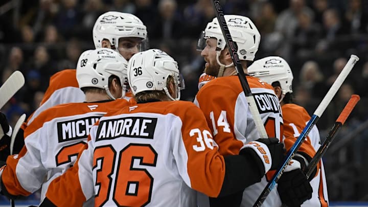 Apr 9, 2025; New York, New York, USA;  Philadelphia Flyers center Sean Couturier (14) celebrates his goal against the New York Rangers with defenseman Emil Andrae (36) and right wing Matvei Michkov (39) during the third period at Madison Square Garden.