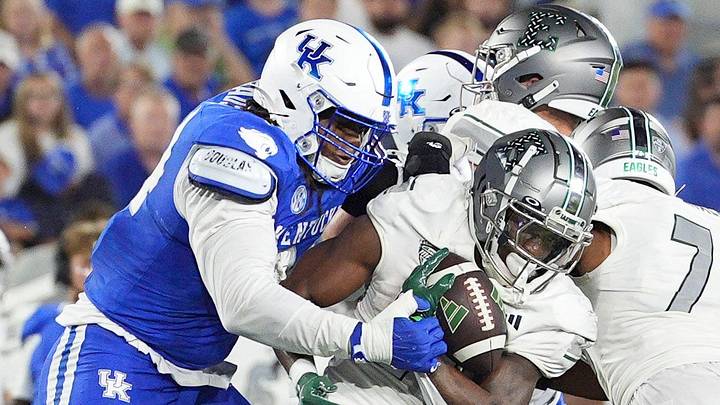 Kentucky Wildcats defensive lineman Tavion Gadson (94) stops Eastern Michigan Eagles wide receiver Antonio Floyd (26) during the Wildcats win over the Eagles in Lexington, Kentucky Saturday, Sept. 13, 2025. Kentucky Wildcats defensive lineman Tavion Gadson (94) stops Eastern Michigan Eagles wide receiver Antonio Floyd (26) during the Wildcats win over the Eagles in Lexington, Kentucky Saturday, Sept. 13, 2025.