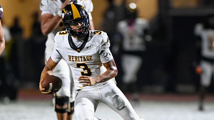 American Heritage star quarterback Dia Bell runs for yardage during a season-opening win over St. Joseph Prep on Aug. 22, 2025.