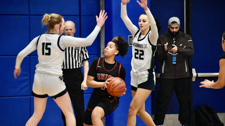Woodinville's Kamryn Wille, left, and Jazzy Wilkerson surround Union's Myla Larry in Class 4A regional game at Bellevue College.