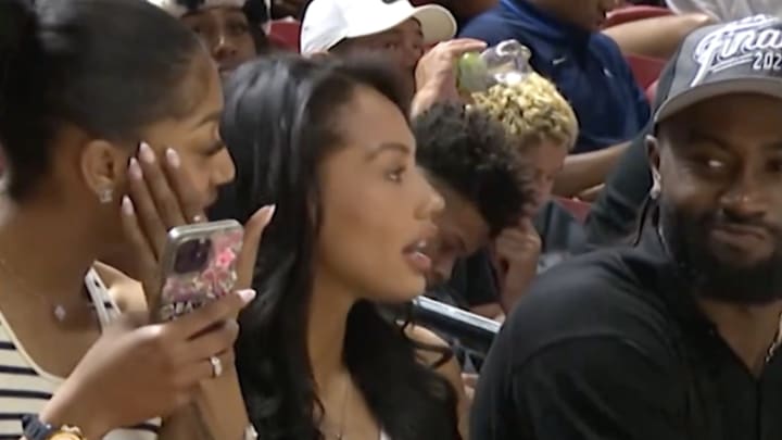 Angel Reese, Kysre Gondrezick and Brown courtside.