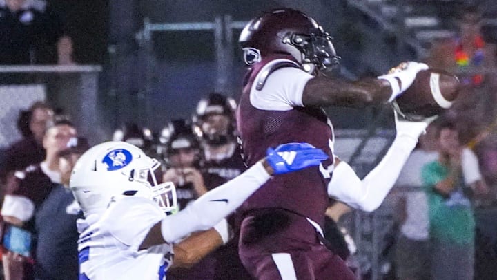 Appoquinimink's Jahsiear Rogers makes a catch in front of Dover's Andrew Taylor in the Jaguars' 34-20 win at Appoquinimink, Sept 5, 2025.
