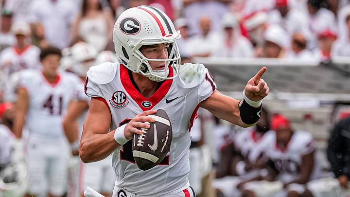 Georgia Bulldogs quarterback Gunner Stockton (14) rolls out and runs against the Western Kentucky Hilltoppers